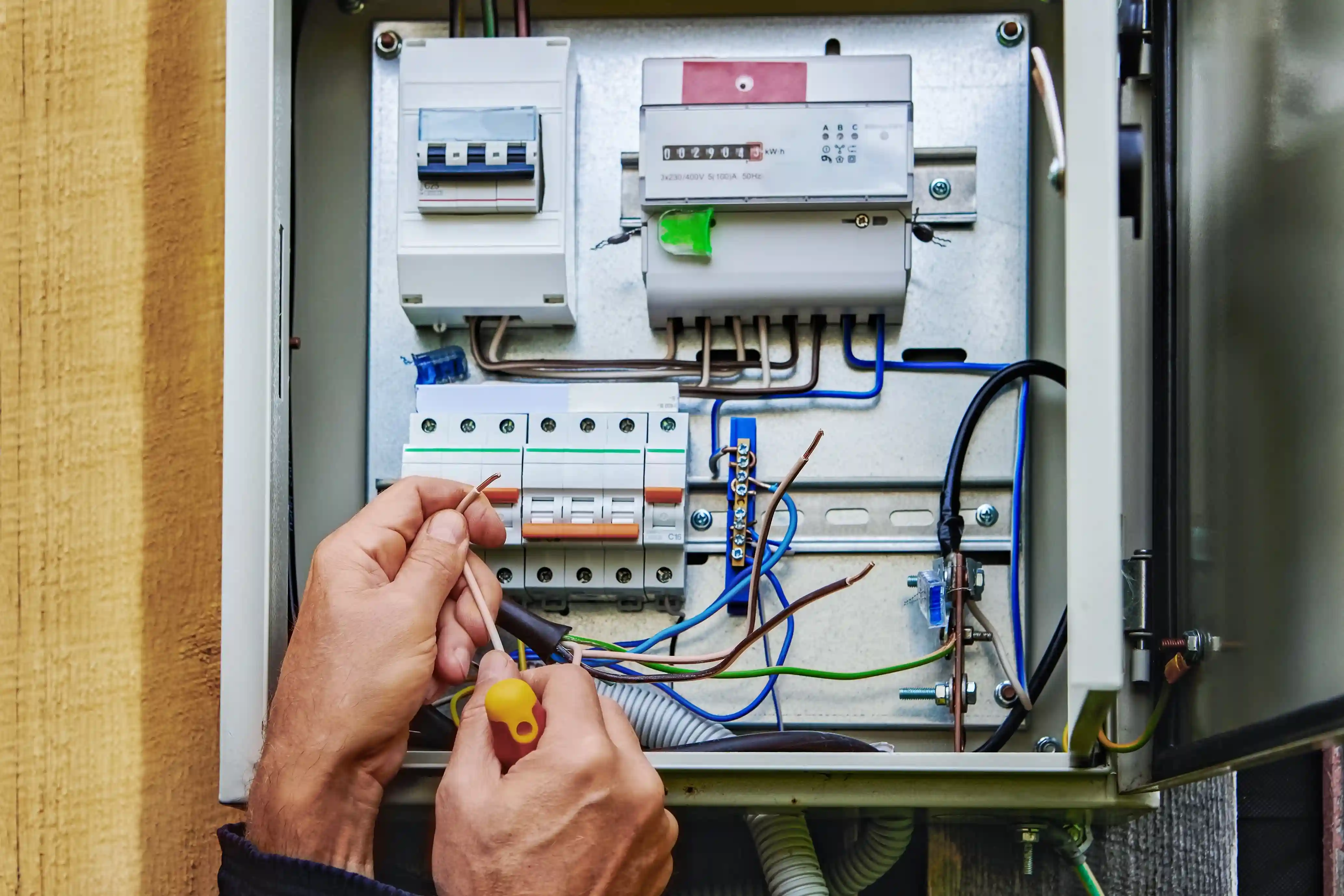 Licensed electrician in Bentleigh performing professional switchboard maintenance and safety inspection on a residential electrical panel