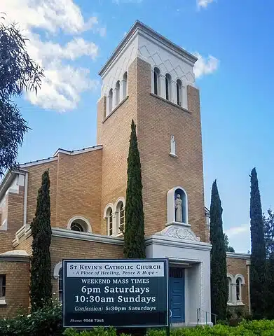 "St Kevin's Church in Ormond, Melbourne, showcasing a traditional architectural design with a red-brick exterior, arched windows, and a prominent entrance.