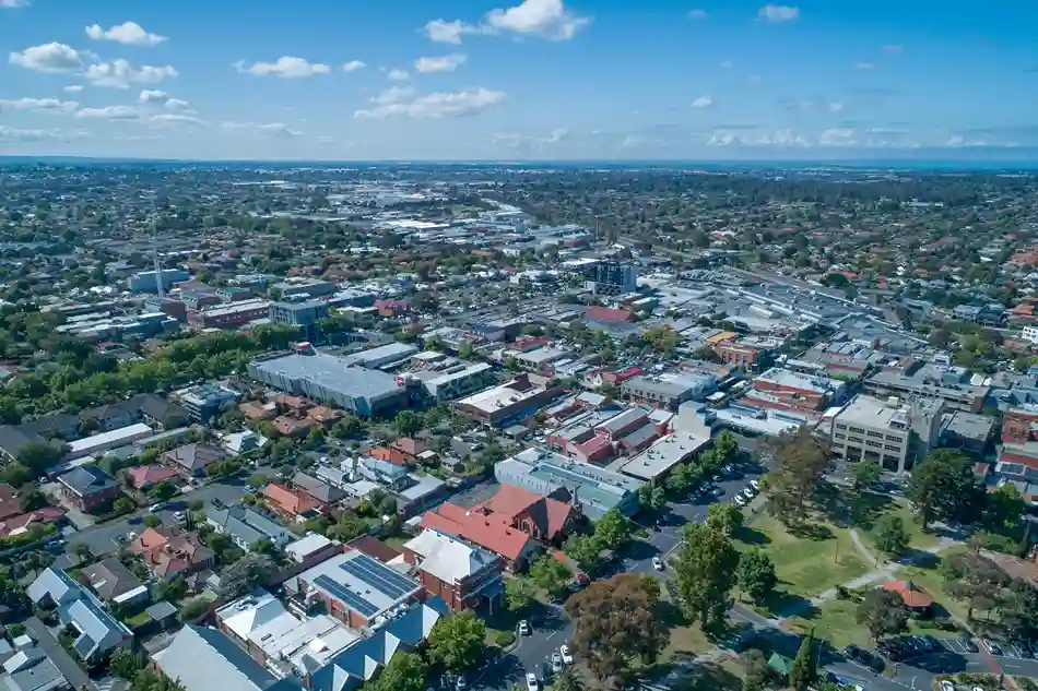 Wide aerial view of Oakleigh showing commercial and residential areas under a clear blue sky.