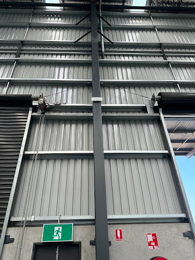 Industrial building featuring a motorized roller shutter door system.