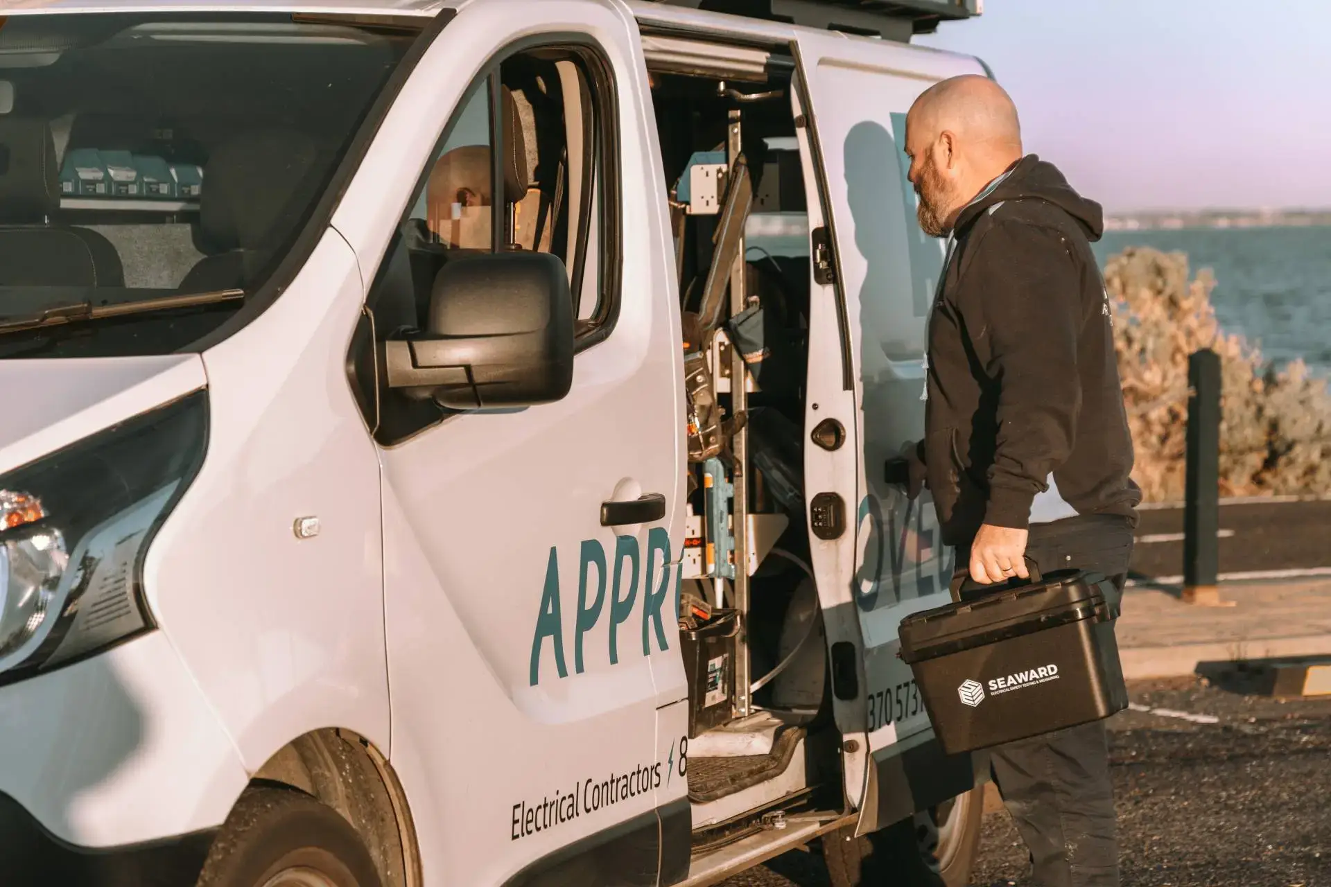 Approved Electrix Electrician collecting tools from a service van before starting electrical work