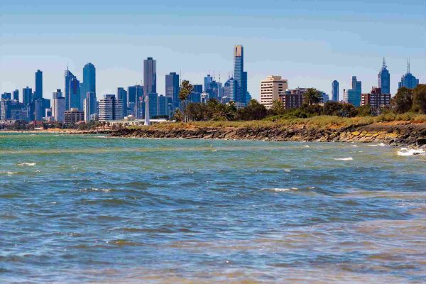 View of Melbourne city skyline from Elwood Beach on a sunny day.
