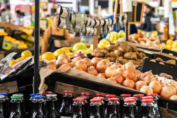 Fresh produce and goods on display at a bustling Prahran market stall.