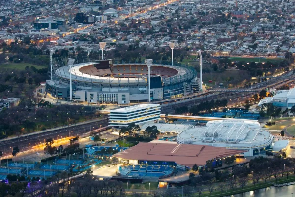 Aerial view of Richmond's sports precinct featuring the iconic sports stadium and surrounding cityscape at dusk