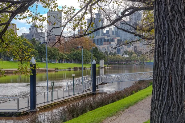 Scenic view of the Yarra River winding through the city of Melbourne in Victoria, Australia, highlighted by lush parklands and urban architecture.