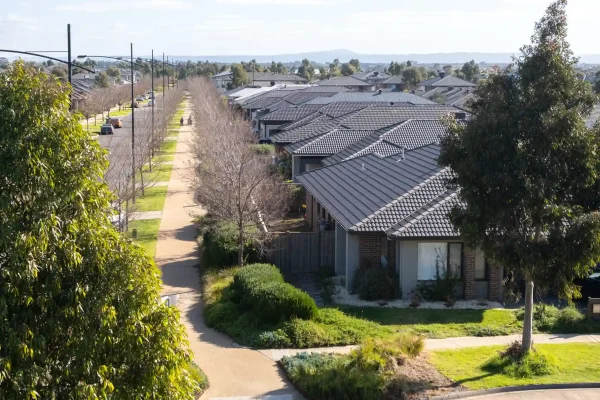 Residential suburban neighborhood street view with row houses and greenery in Melbourne.
